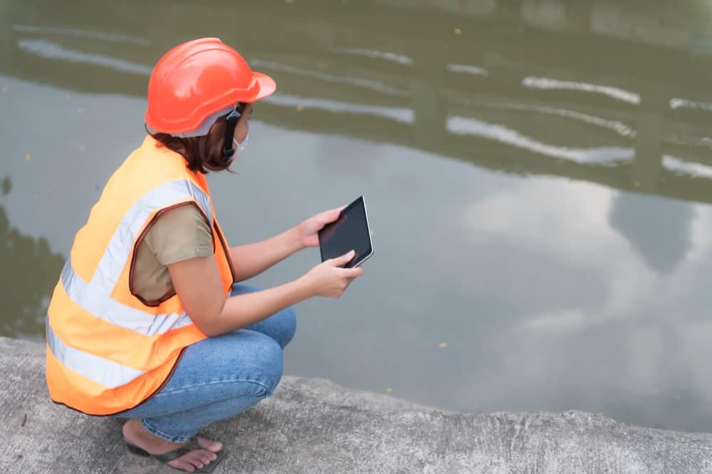 asian female engineering working xa sewage treatment plantmarine biologist analysing water test resultsworld environment day concept min