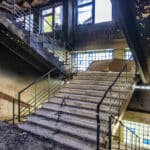 Burned interiors after fire in industrial or office building. Walls and staircase in black soot